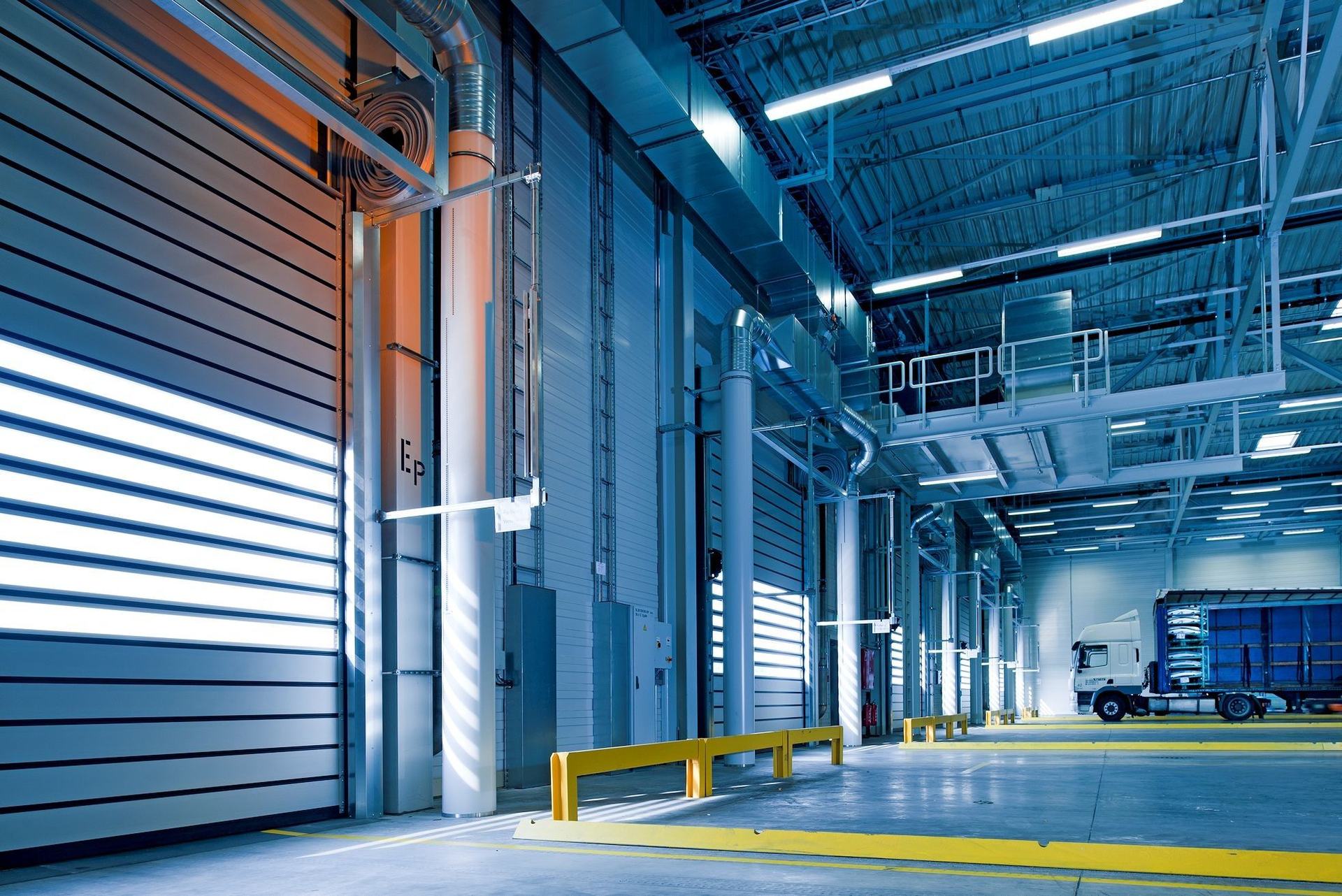 Interior of a large industrial building with steel structure and machinery